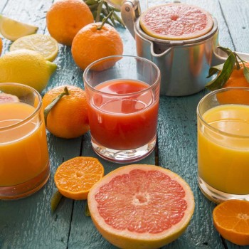 glasses-of-orange-juice--grapefruit-juice-and-multivitamine-juice--juice-squeezer-and-fruits-on-wood-548008985-571e7ce25f9b58857d2f53cb